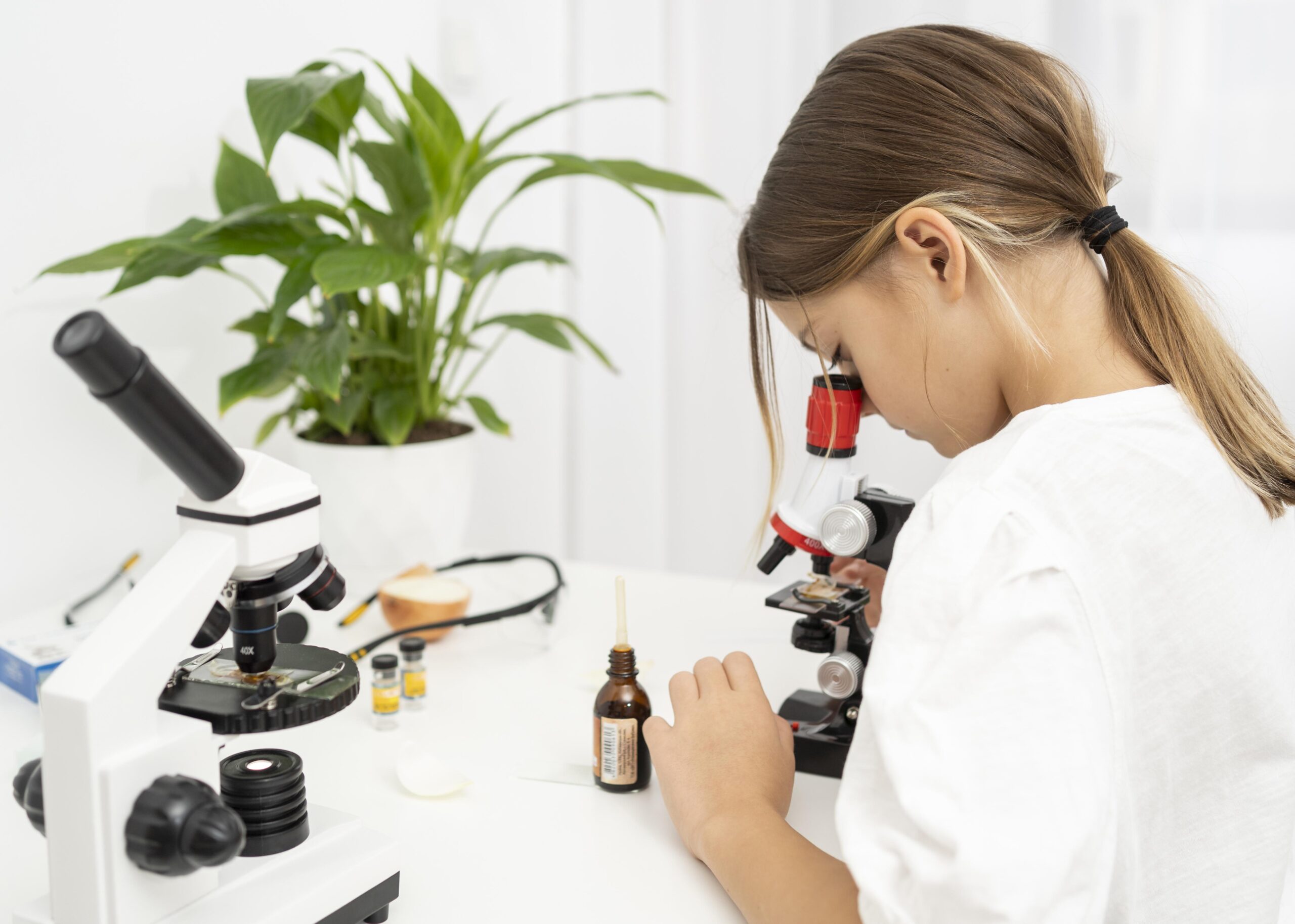 side-view-girl-looking-into-microscope